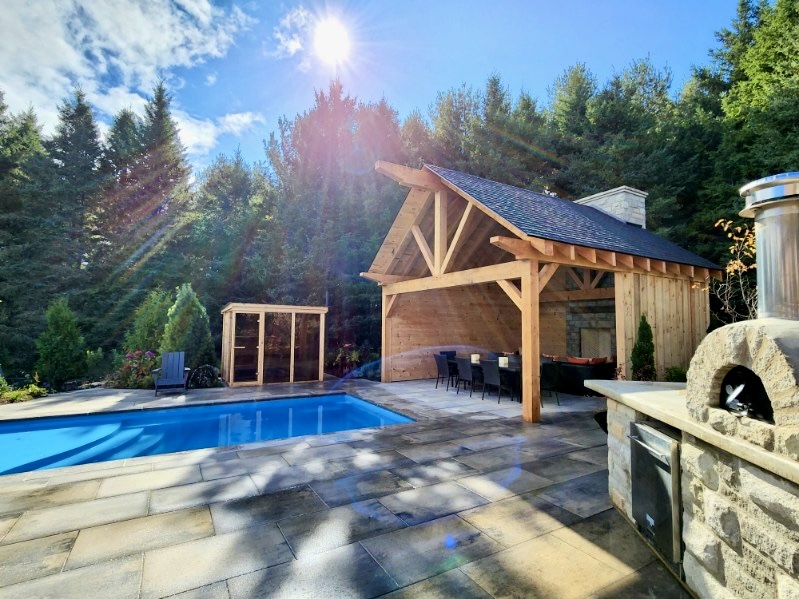 Completed custom home landscape with pool, pavilion, and coordinated exterior construction by Headwaters Landscape Design & Construction